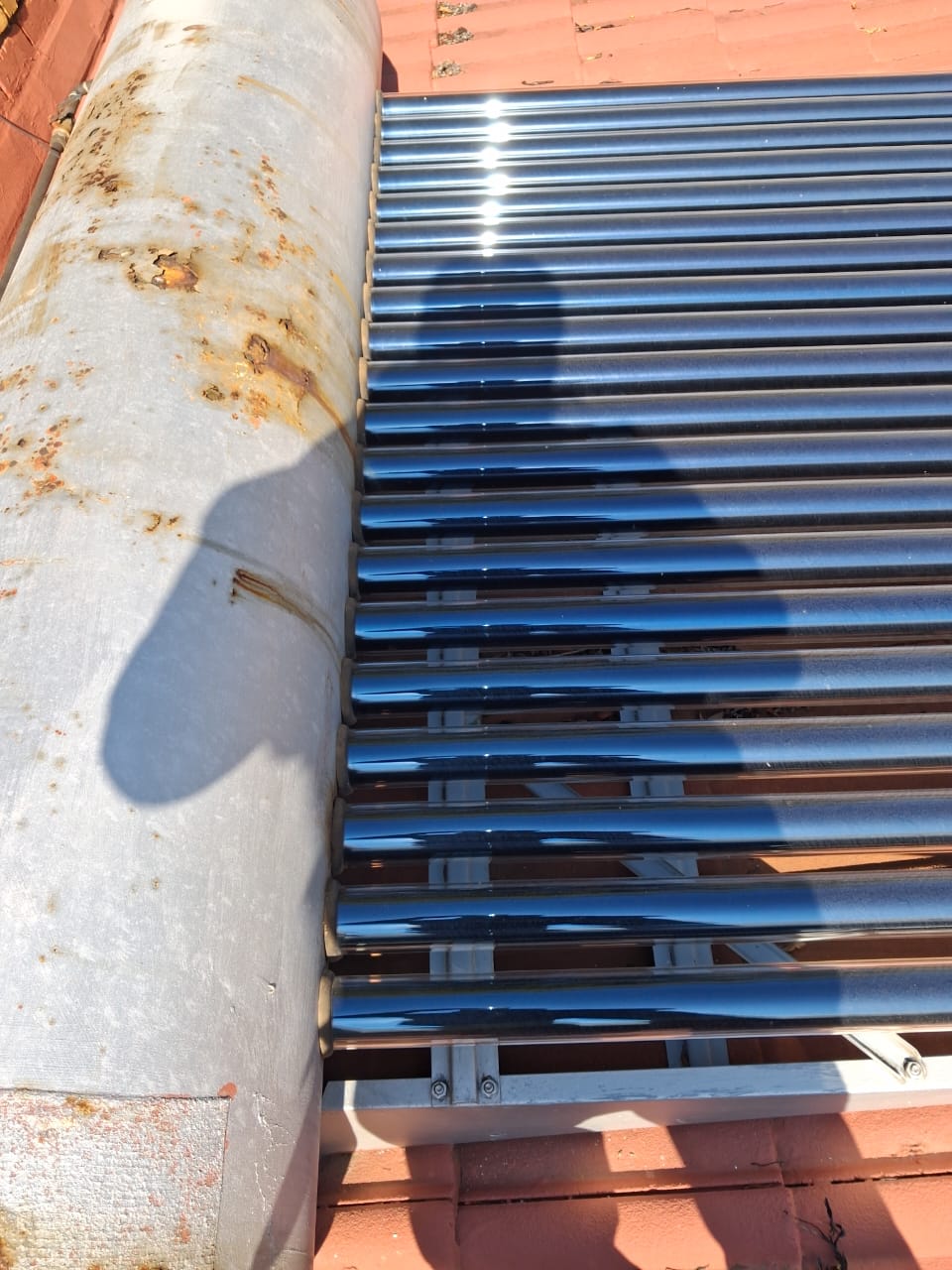 Solar evacuated-tube collector installed on a tiled roof